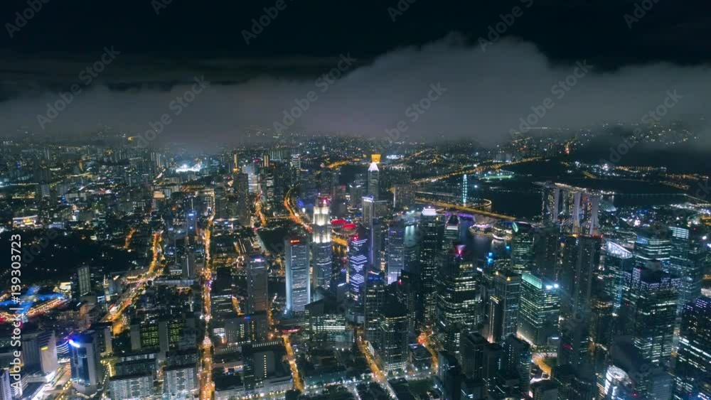 Singapore night Drone is flying in clouds Aerial night view Singapore night Drone is flying in clouds Aerial night view