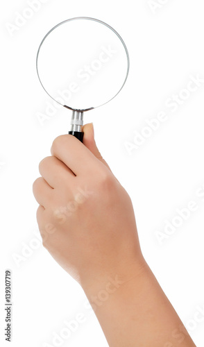 Female hand holding the magnifying glass isolated on white background