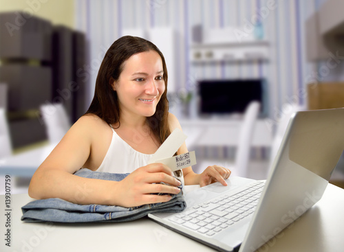 smiling saleswoman working with laptop