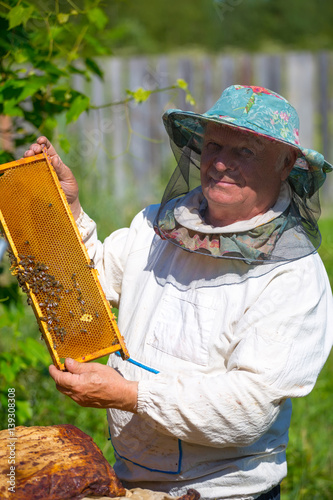 Beekeeper with honeycombs in hands © Igor Dmitriev