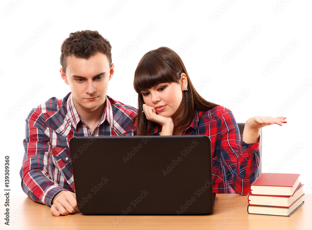 Teenagers studying together with a laptop