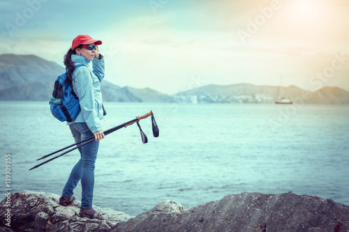 Woman Traveler with Backpack hiking in Mountains with beautiful summer landscape on background mountaineering sport lifestyle concept