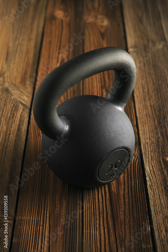 Fototapeta Naklejka Na Ścianę i Meble -  iron kettlebell on wooden background Sport equipment background with copyspace