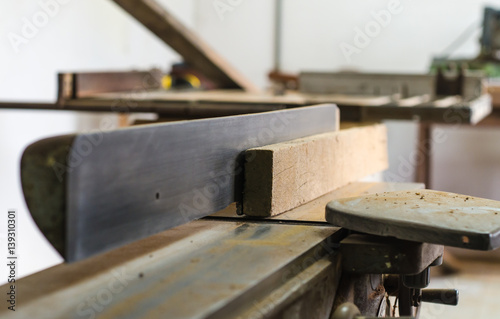 The carpenter was working furniture wood in studio , Soft-focus image