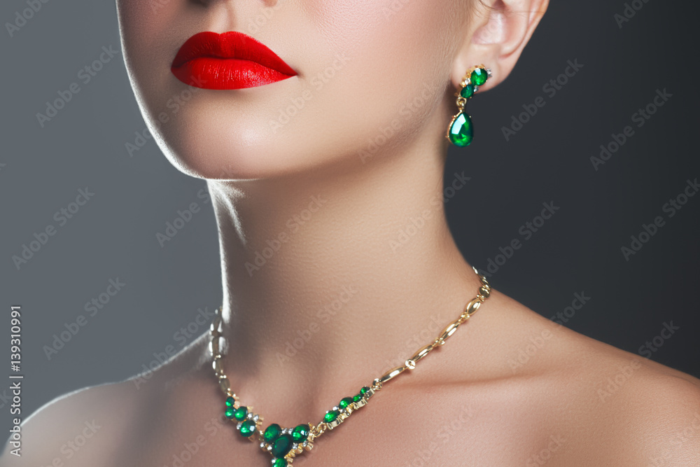 Elegant fashionable girl with jewelry. Beautiful woman with emerald necklace. Young beauty model girl with emerald pendant. Jewellery and accessories. Fashion and beauty salon. Perfect lip makeup