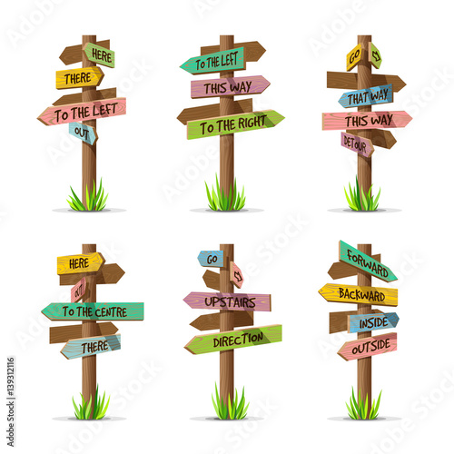 Colored wooden arrow signboards direction vector set. Wood sign post concept with grass. Board pointer illustration with text isolated on a white background