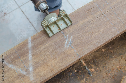 The carpenter was working furniture wood in studio , Soft-focus image