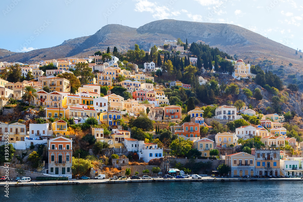 Fototapeta premium Greece. Dodecanesse. Island Symi Simi . Colorful houses on rocks