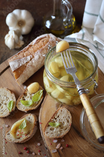 Garlic confit in jar and french spread bread photo