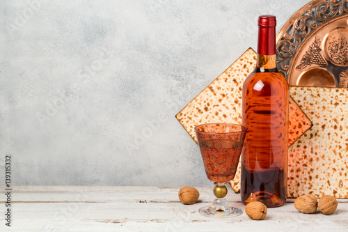Passover holiday concept with wine and matzoh over rustic background