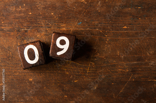 Cube numbers on old wooden table with copy space, 09