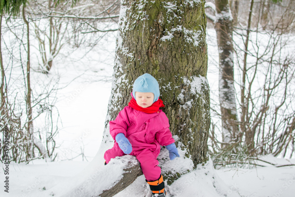 child at a tree in winter child at a tree in winter