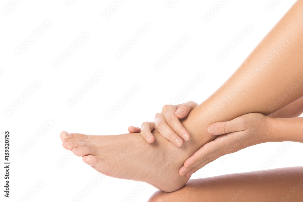 Woman is touching her injured ankle