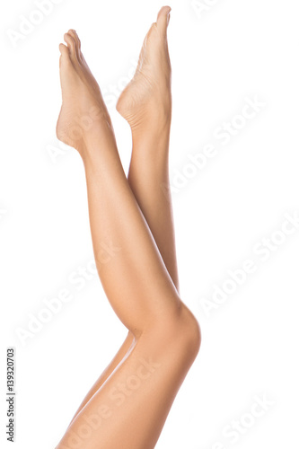 Fényképezés Female legs on white background