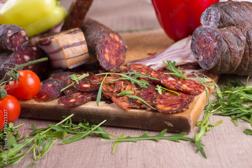 Smoked meat delicatessen on a wooden board