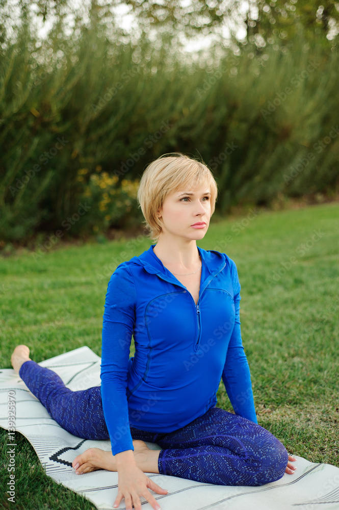 beautiful woman doing yoga exercises in park beautiful woman doing yoga exercises in park