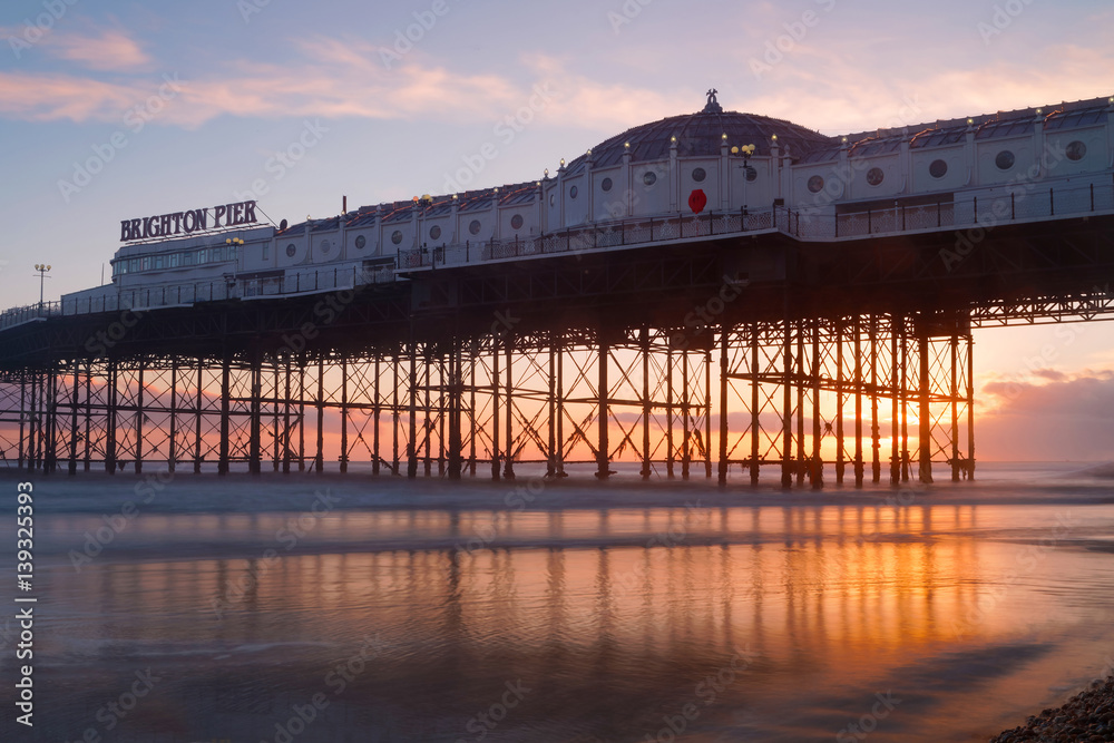 Brighton pier at sunset, warm red and orange colors