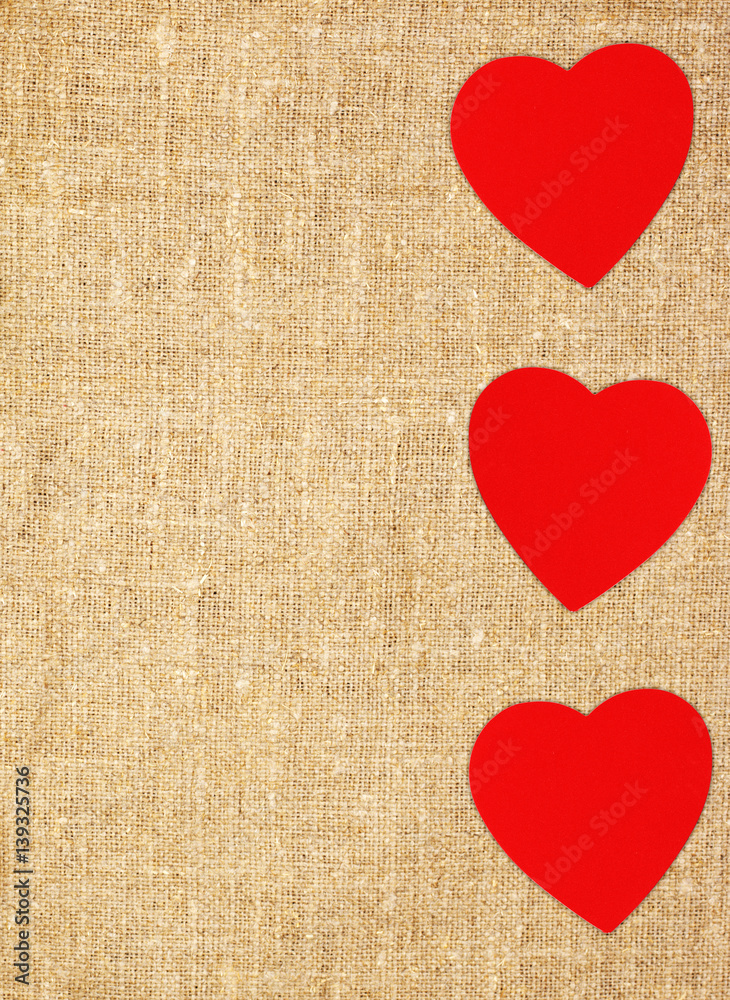 Border frame of red hearts on sack canvas burlap background texture