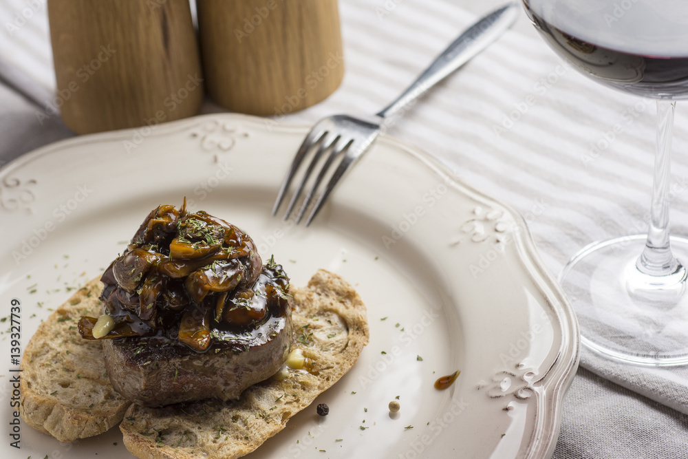 Beef Steak Fillet Covered with Mushroom Sauce on Toasted Baguette Bread with Melting Butter and Herbs Beef Steak Fillet Covered with Mushroom Sauce on Toasted Baguette Bread with Melting Butter and Herbs
