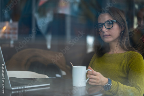 Beautiful young woman working in a cafe