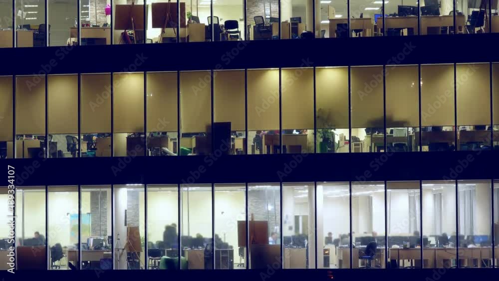 Skyscraper with people working within. Business center with lighting windows with people working overtime. Zoom effect. Time lapse Skyscraper with people working within. Business center with lighting windows with people working overtime. Zoom effect. Time lapse