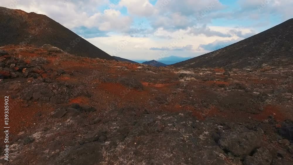 The most beautiful flight copter over the hardened lava. Flying through the fire volcano The most beautiful flight copter over the hardened lava. Flying through the fire volcano