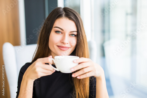 beautiful young woman drinking coffee