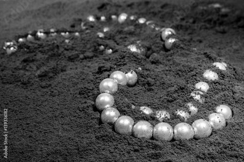 Perlenkette mit Asche überzogen