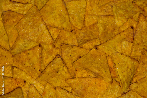 A lots of nachos chips as background. photo