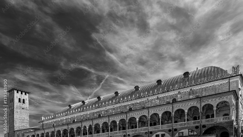 The famous Palazzo della Ragione palace in Piazza delle Erbe in Padua, Italy, against a beautiful sky, in black and white