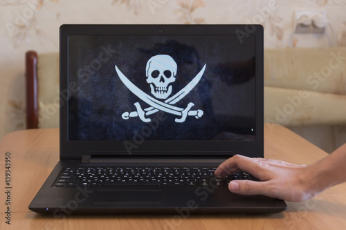 Laptop with a picture of a pirate flag 