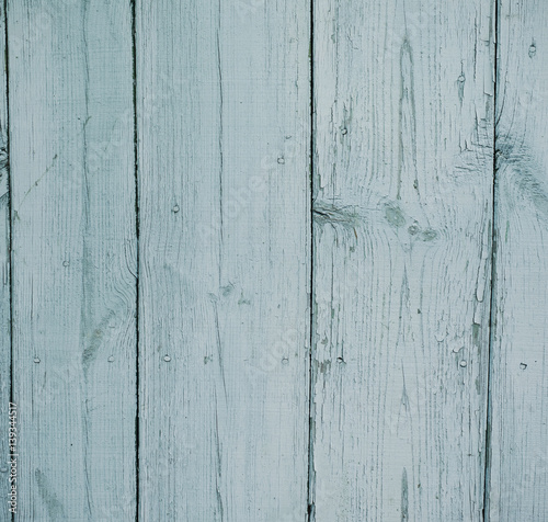 Light blue cracked wooden background with aged planks