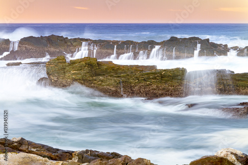Tidal water in motion over rocks at Storms River mouth in Eastern Cape  South Africa