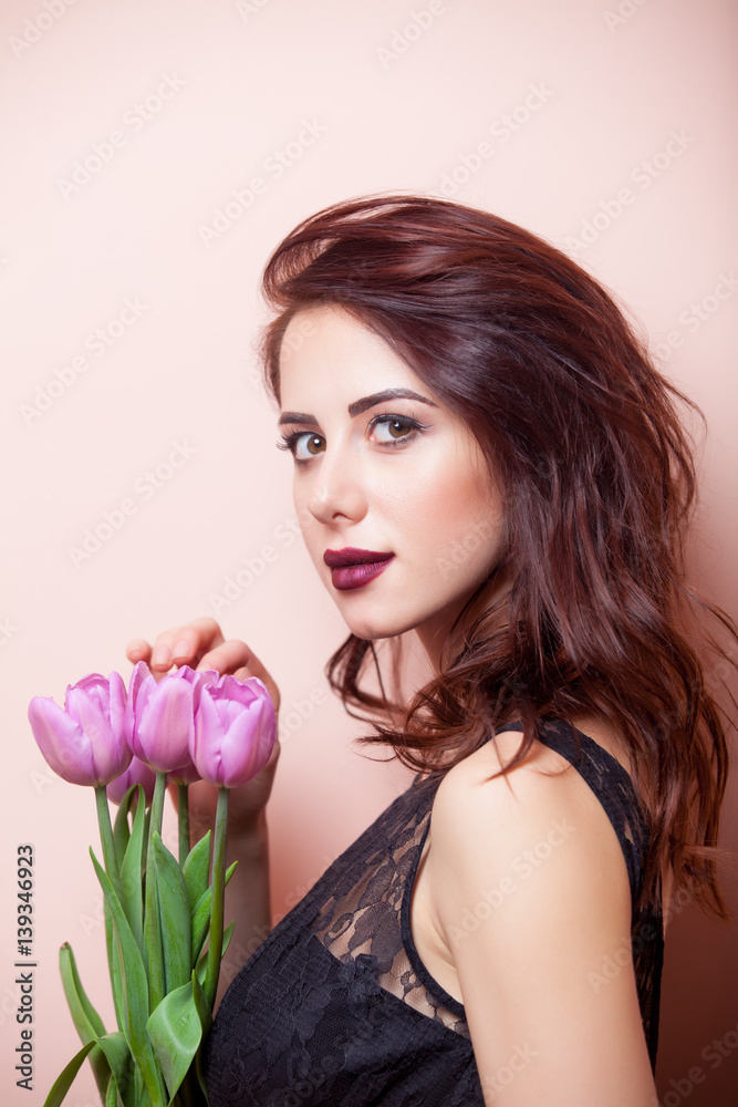 beautiful young woman with bunch of tulips on the wonderful pink background beautiful young woman with bunch of tulips on the wonderful pink background