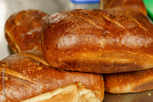 Freshly baked bread to be cut into a restaurant kitchen.