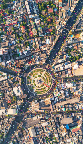 Road roundabout with car lots Wongwian Yai in Bangkok,Thailand. street large beautiful downtown at evening light. Aerial view , Top view ,cityscape ,Rush hour traffic jam