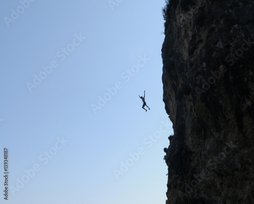man jumps from a rock