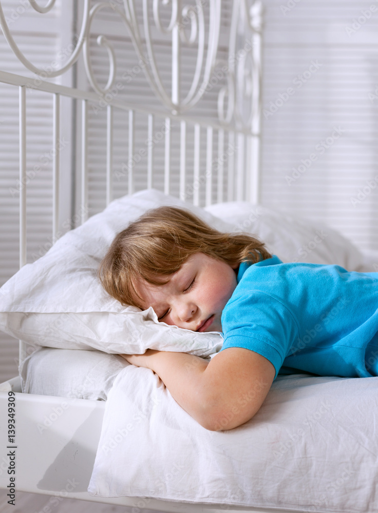 baby is sleeping in the room at home on the white bed baby is sleeping in the room at home on the white bed