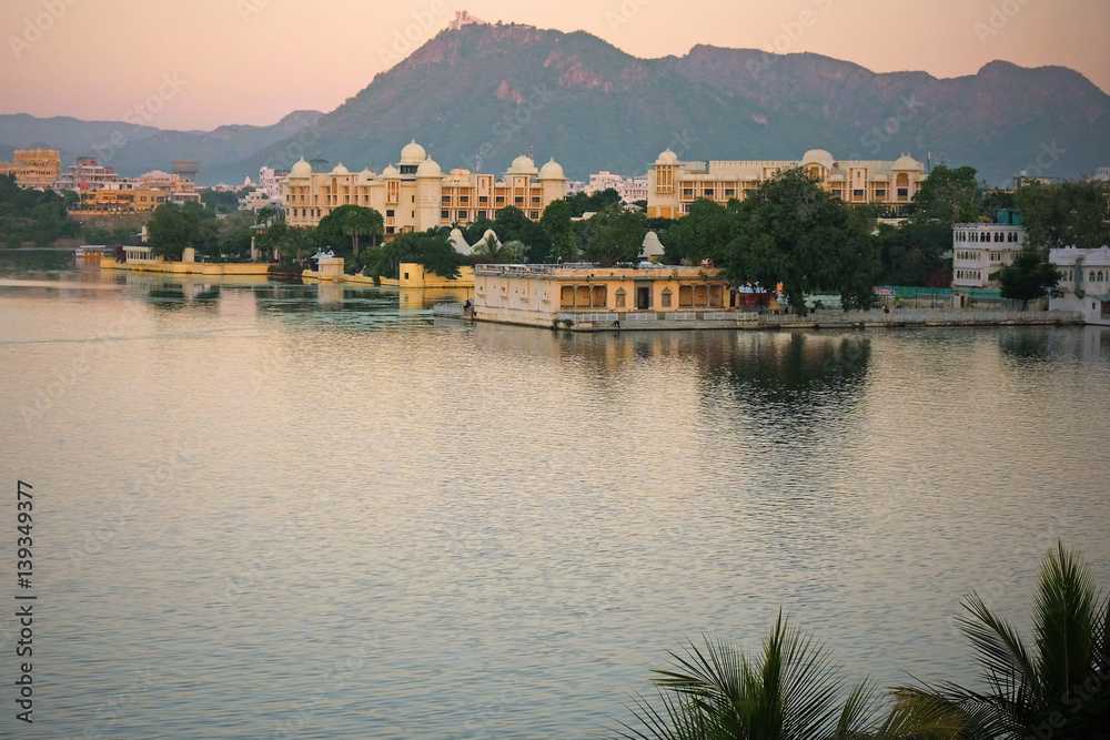 The city of Udaipur at dusk in early winter. It is situated on the edge of Lake Pichola and surrounded by the Aravalli Hills in Rajasthan