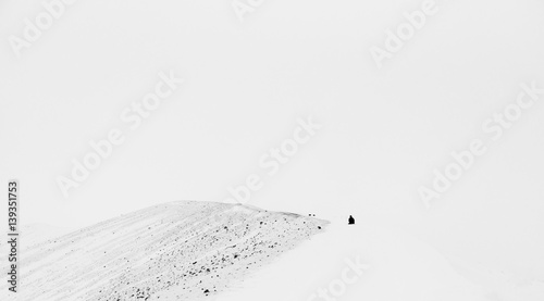 Wallpaper Mural Tiny human figure on the edge of a volcano crater - breathtaking Iceland in winter - amazing landscapes, storms and blizzards - photographers paradise Torontodigital.ca