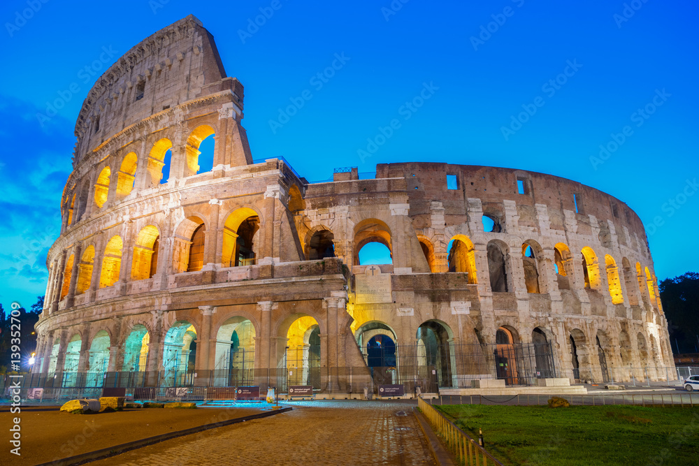 view of Colosseum illuminated at blue night in Rome, Italy