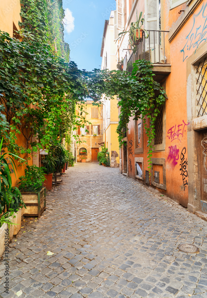 view of old town italian narrow street with blue sky in Trastevere, Rome, Italy