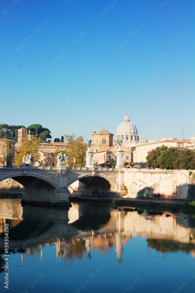 St. Peter's cathedral dome over bridge and river in Rome, Italy