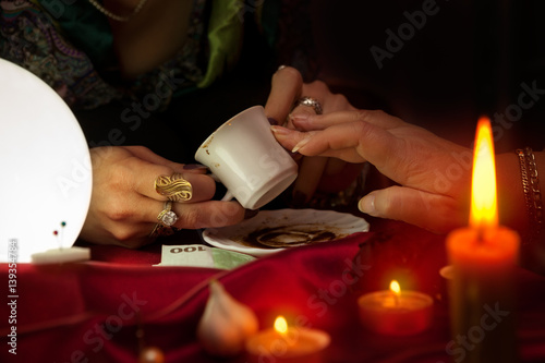 Coffee fortune telling by old gypsy fortune teller photo