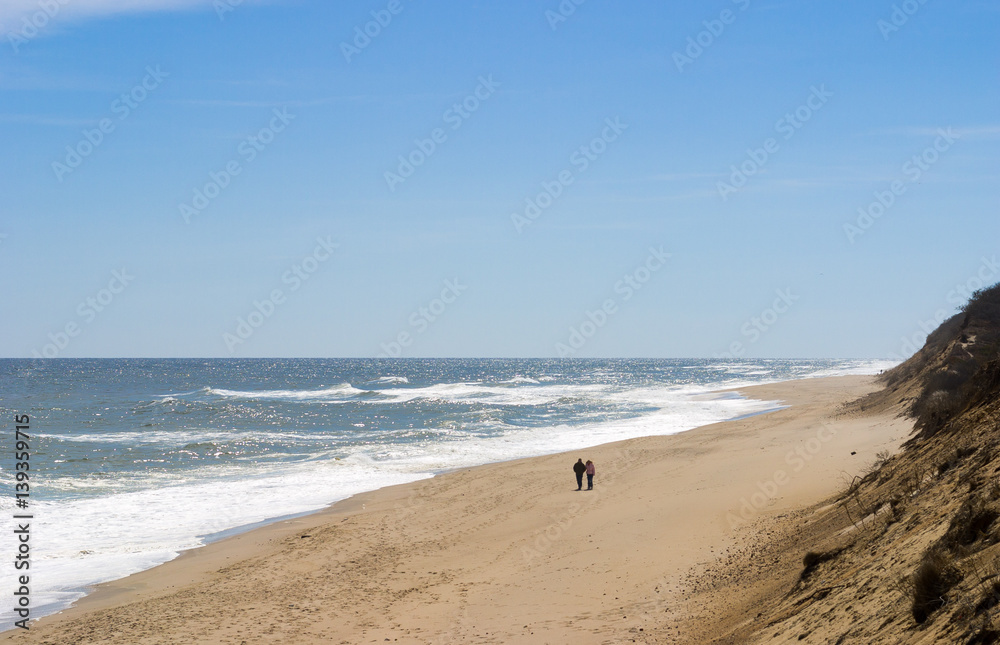 couple walking along seashore at Cape Cod