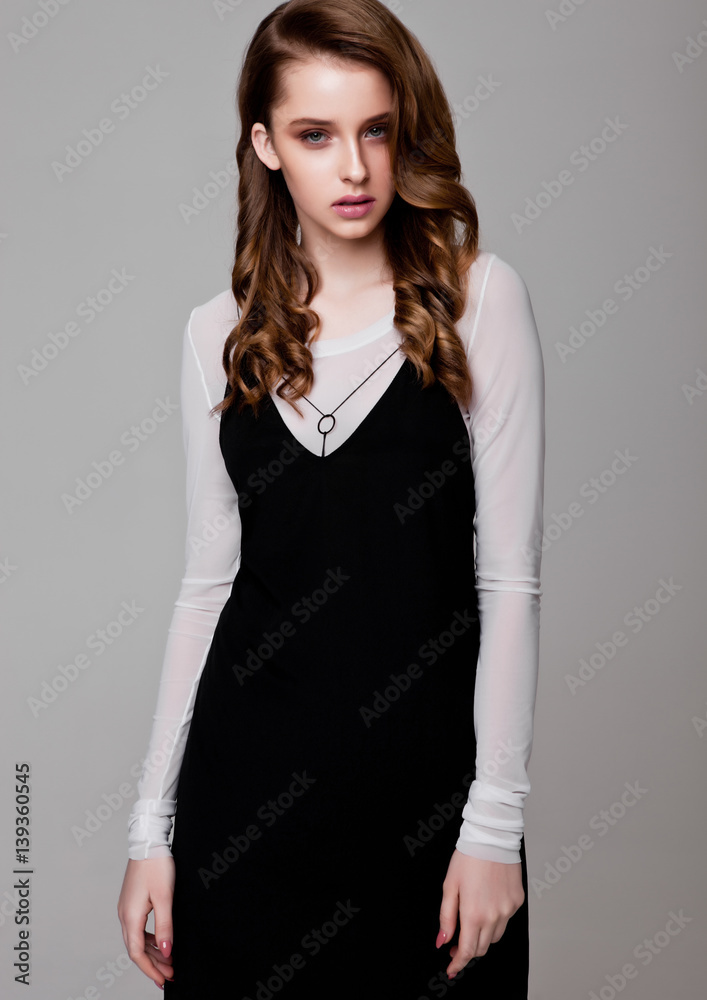Young beautiful fashion model wearing black dress