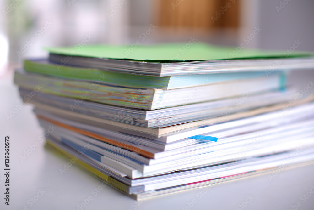 close up of stack of papers on white background close up of stack of papers on white background