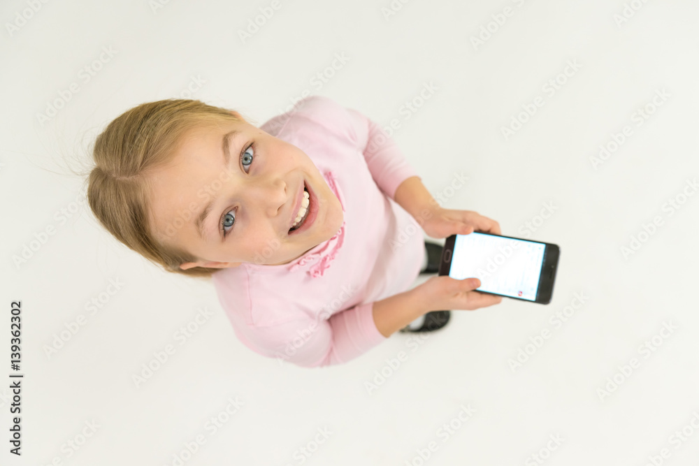 The happy girl stand with a smartphone. View from above The happy girl stand with a smartphone. View from above