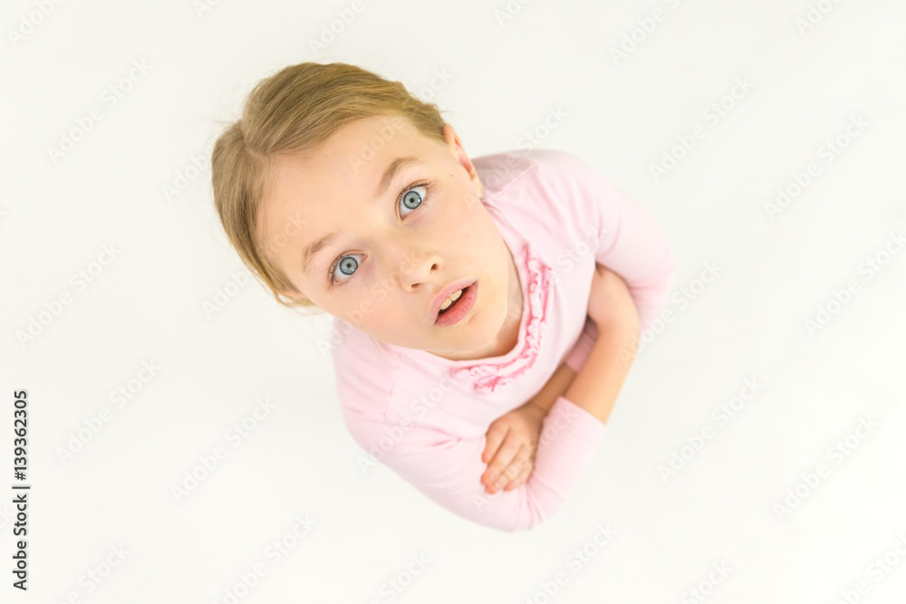 The surprised girl look to the camera. View from above The surprised girl look to the camera. View from above