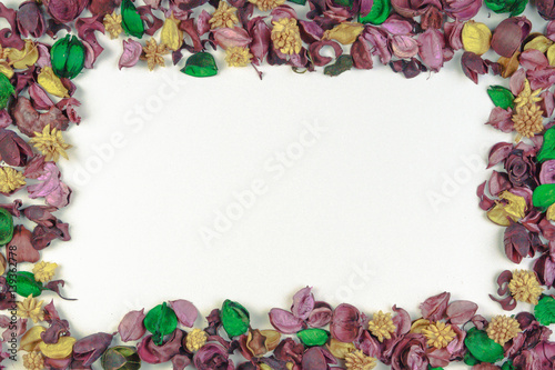 Dried flowers and leaves composition frame on white background. Top view, flat lay. Copy space for text or image
